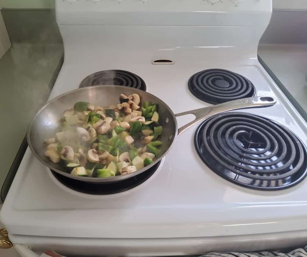 vegetables being cooked on the stove